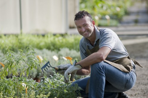 Gardener using tools with protective equipment during maintenance